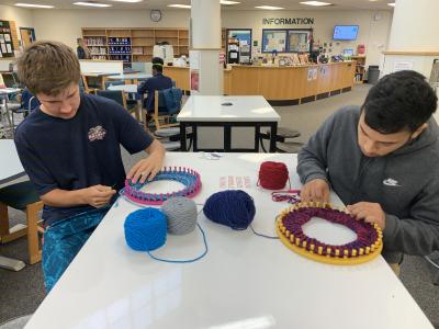 Students knitting for "Hats for Some"